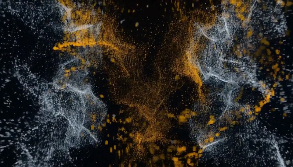 Frame at five seconds: amber threads weaving through converging particle streams